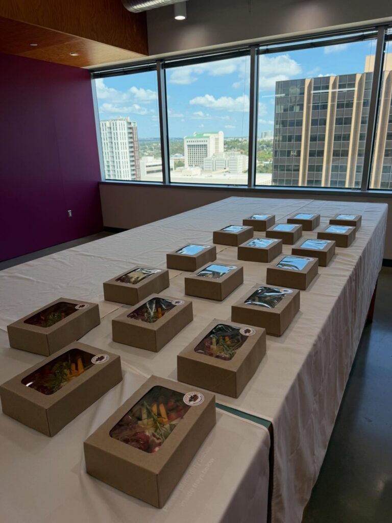 Elevated boxes set out on a conference table with a city view