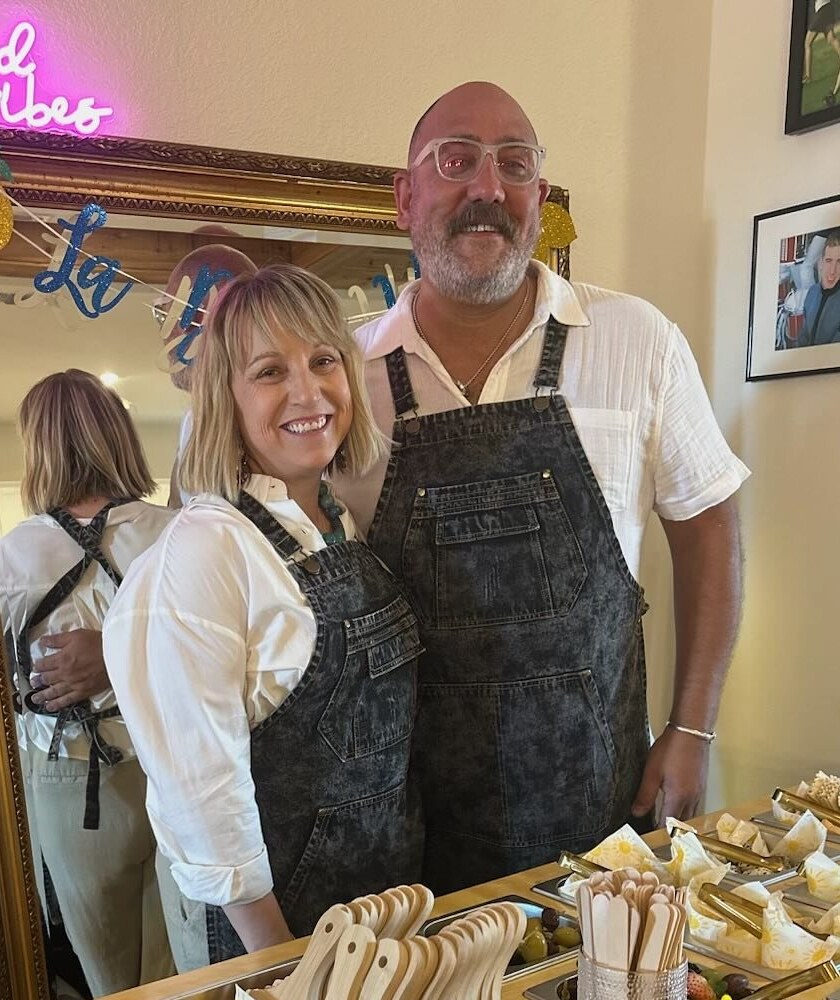 Bat City Boards owners Brie Grant and Corey Riser behind their charcuterie cart