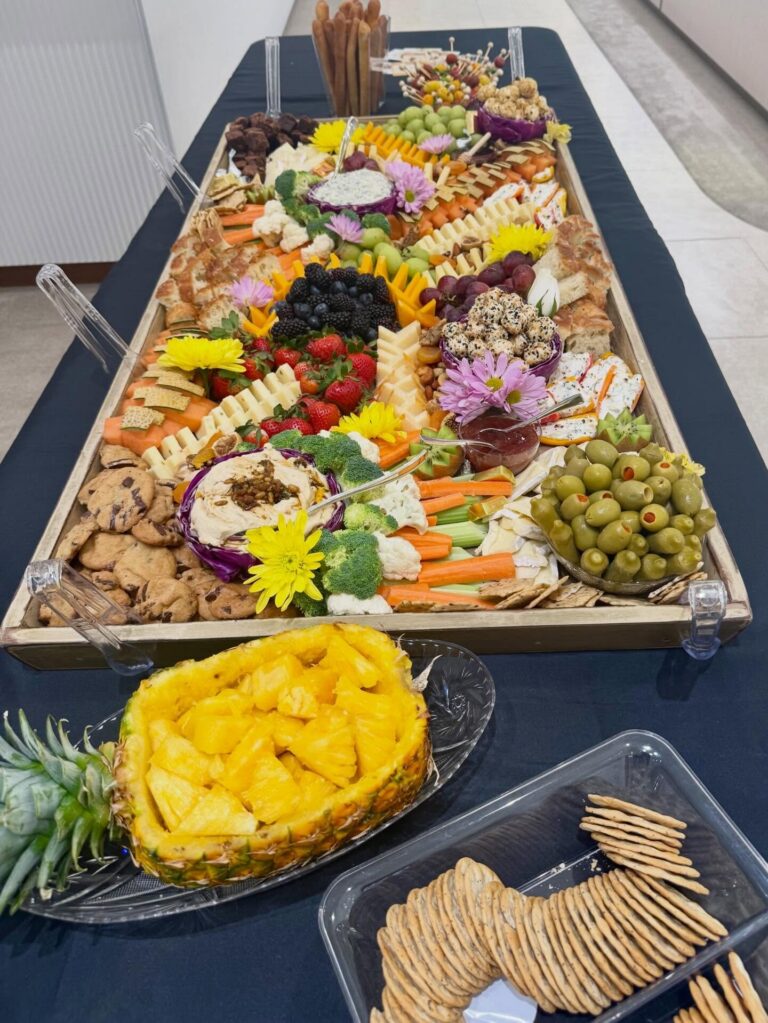 Grazing table with a carved pineapple and crackers