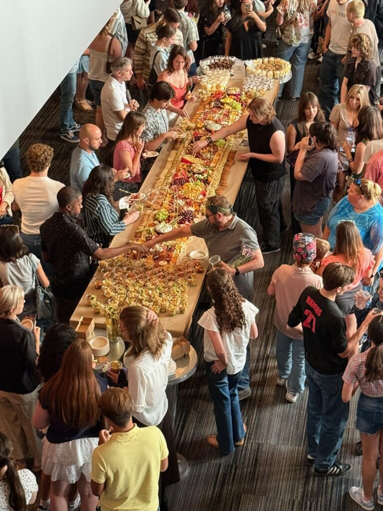 Guests serving themselves from a large grazing table