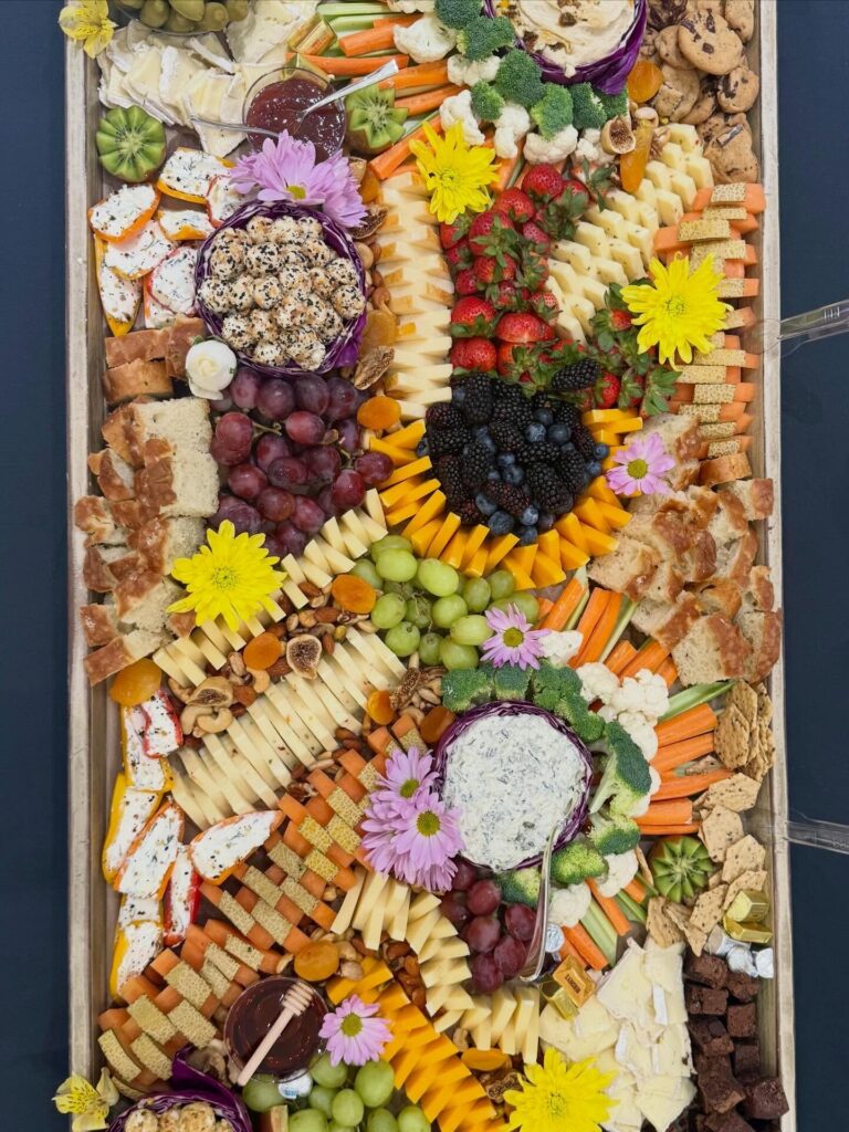 Overhead of the Zadok grazing table: flowers, cheeses, dips, crackers