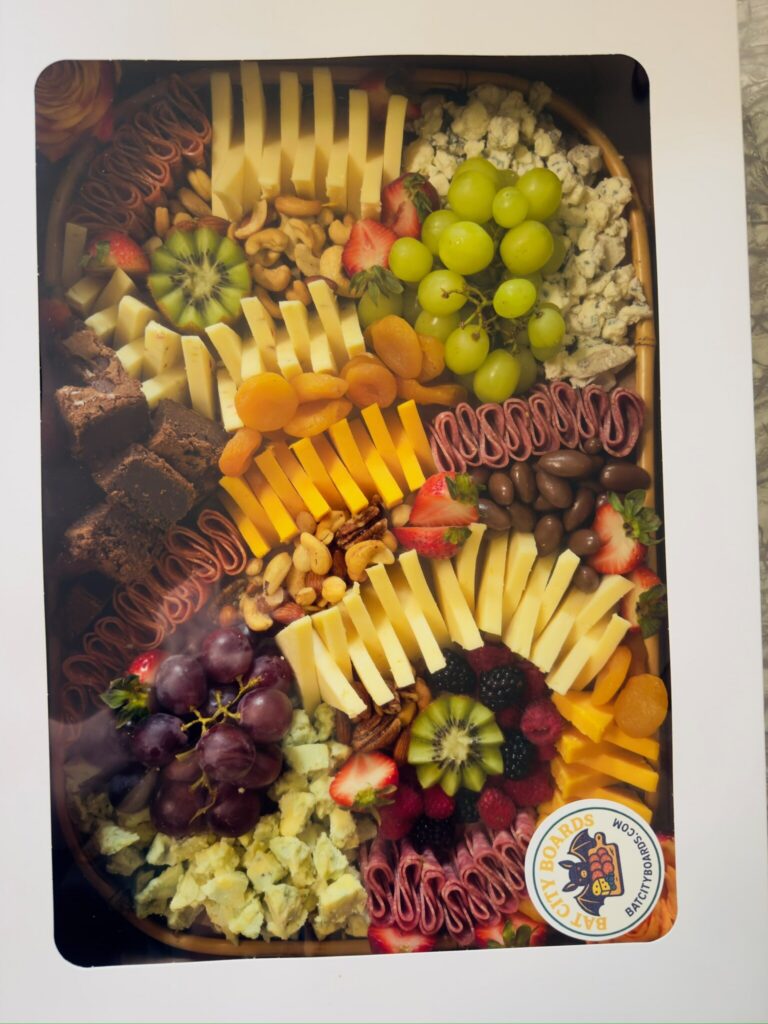 Large custom charcuterie board packaged for delivery