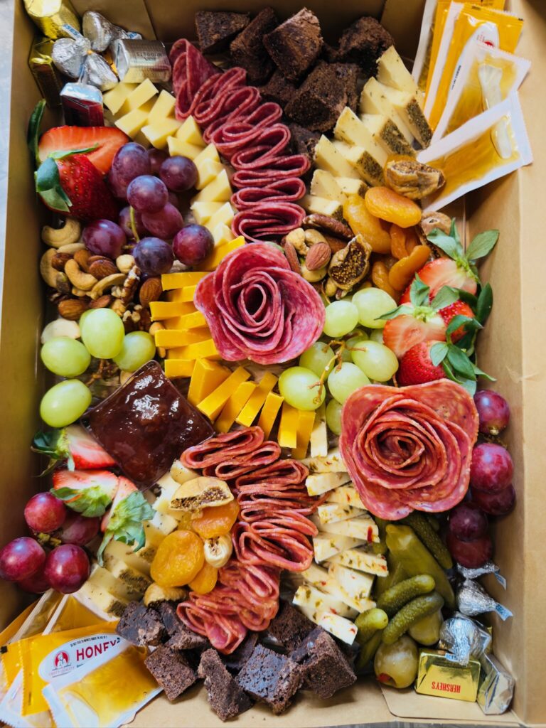 Medium custom charcuterie board with salami roses, berries and cheeses