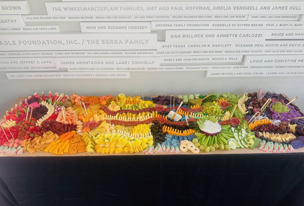 Rainbow-themed grazing table at an event